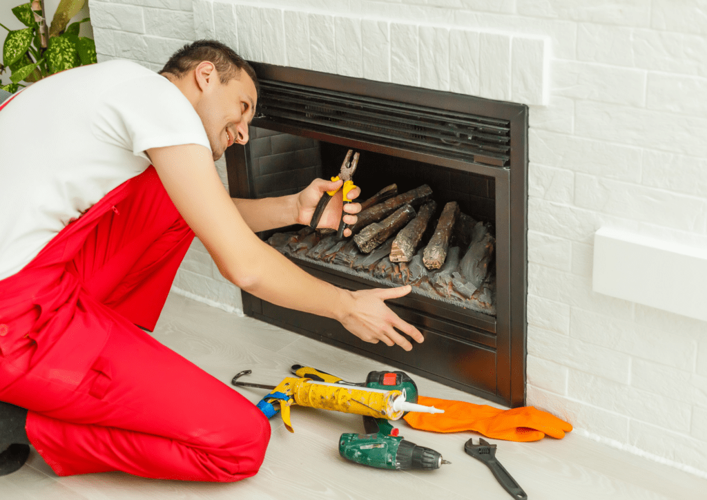 Bir işçi ev şöminesini monte ediyor.